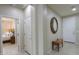 Inviting hallway with tiled flooring, a decorative mirror, and easy access to the bedroom at 22651 E Via Del Verde --, Queen Creek, AZ 85142