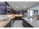 Modern eat-in kitchen with granite countertops, dark wood cabinets, and stainless steel appliances at 22651 E Via Del Verde --, Queen Creek, AZ 85142