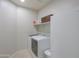 Functional laundry room with a modern washer and dryer, built-in shelving, and ample storage space at 22651 E Via Del Verde --, Queen Creek, AZ 85142
