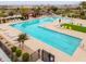 Community pool features ample lounge seating, vibrant umbrellas, and manicured landscaping at 22651 E Via Del Verde --, Queen Creek, AZ 85142