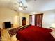 Comfortable bedroom featuring a ceiling fan, wood-style floors, and ample natural light at 23087 W Antelope Trl, Buckeye, AZ 85326