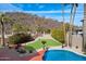 A backyard oasis featuring a refreshing pool, desert landscaping, and a hillside view at 23225 N 23Rd Pl, Phoenix, AZ 85024