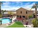 Aerial view of the backyard featuring a refreshing pool, spacious patio, mature palms, and a charming pergola for entertaining at 23225 N 23Rd Pl, Phoenix, AZ 85024
