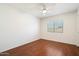 A bedroom with hardwood flooring and a view of the exterior through a window at 23225 N 23Rd Pl, Phoenix, AZ 85024