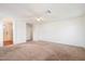 A spacious bedroom with carpet and a ceiling fan, next to the bathroom and closet at 23225 N 23Rd Pl, Phoenix, AZ 85024