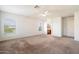 A bright, spacious bedroom with carpet, a ceiling fan, and views from two windows at 23225 N 23Rd Pl, Phoenix, AZ 85024