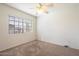 This bedroom features a ceiling fan and a large window for natural light at 23225 N 23Rd Pl, Phoenix, AZ 85024