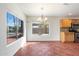 Dining area with a chandelier, large windows, tile flooring, and oak cabinets at 23225 N 23Rd Pl, Phoenix, AZ 85024