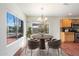 Cozy dining area with a chandelier, large windows, and oak cabinets at 23225 N 23Rd Pl, Phoenix, AZ 85024