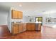 Updated kitchen with stainless steel appliances, oak cabinets, and open access to the dining area at 23225 N 23Rd Pl, Phoenix, AZ 85024