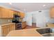 Well-lit kitchen with stainless steel appliances, oak cabinets, and tile flooring at 23225 N 23Rd Pl, Phoenix, AZ 85024