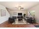 Living room showing designer furnishings, a ceiling fan, and a large window with a backyard view at 23225 N 23Rd Pl, Phoenix, AZ 85024
