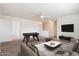 A spacious living room featuring a foosball table and a comfortable seating area at 23225 N 23Rd Pl, Phoenix, AZ 85024
