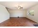 Living room with tile floor, a ceiling fan, a window with a backyard view, and a staircase to the second floor at 23225 N 23Rd Pl, Phoenix, AZ 85024