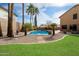 An in-ground pool features an outdoor lounge area and tropical landscaping at 23225 N 23Rd Pl, Phoenix, AZ 85024