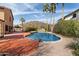 An in-ground pool with a patio and landscaped exterior at 23225 N 23Rd Pl, Phoenix, AZ 85024