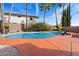 An in-ground pool is surrounded by a patio and desert landscaping at 23225 N 23Rd Pl, Phoenix, AZ 85024