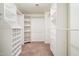 A large walk-in closet featuring custom shelving and storage at 23225 N 23Rd Pl, Phoenix, AZ 85024