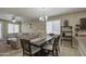 Open-concept dining room featuring a modern chandelier, and connection to the living area at 23850 W Levi Dr, Buckeye, AZ 85326