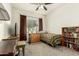 Cozy bedroom featuring a twin bed, natural light, and a fully stocked bookcase at 25913 W Cat Balue Dr, Buckeye, AZ 85396