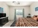 Comfortable bedroom with a large patterned bed, natural light, and matching dark wood furniture at 25913 W Cat Balue Dr, Buckeye, AZ 85396