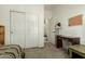 Comfortable bedroom featuring carpeted floors, lots of storage, and a vintage desk at 25913 W Cat Balue Dr, Buckeye, AZ 85396