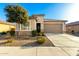 Inviting single-story home featuring a two-car garage and desert landscaping at 25913 W Cat Balue Dr, Buckeye, AZ 85396