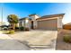 Single-story home featuring a spacious driveway and low-maintenance landscaping at 25913 W Cat Balue Dr, Buckeye, AZ 85396