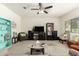 Cozy living room with neutral carpet, ceiling fan, and comfortable seating at 25913 W Cat Balue Dr, Buckeye, AZ 85396