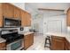 Well-equipped kitchen featuring stainless steel appliances and views to the dining area at 263 W 9Th S Pl, Mesa, AZ 85201