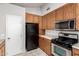 Charming kitchen featuring wood cabinets, modern stainless steel appliances, and a clean, functional design at 263 W 9Th S Pl, Mesa, AZ 85201