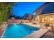 An inviting backyard features a private pool and a cozy lounge area, perfect for evening relaxation at 26711 N 21St Dr, Phoenix, AZ 85085