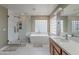 Bright bathroom with a soaking tub, walk-in shower, and double vanity at 26711 N 21St Dr, Phoenix, AZ 85085