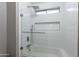 Modern bathroom with tub and shower featuring sleek subway tile and glass enclosure at 26711 N 21St Dr, Phoenix, AZ 85085