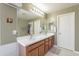 Bathroom with double sinks, vanity, and a view of the soaking tub area at 26711 N 21St Dr, Phoenix, AZ 85085
