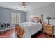 Cozy bedroom with a ceiling fan, window shutters, and hardwood floors for comfort and style at 26711 N 21St Dr, Phoenix, AZ 85085