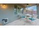 Covered patio features elegant seating, and a ceiling fan for comfort, ideal for relaxation at 26711 N 21St Dr, Phoenix, AZ 85085