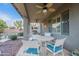 Enjoy outdoor dining under the covered patio with a ceiling fan and comfortable seating at 26711 N 21St Dr, Phoenix, AZ 85085