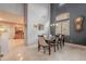 Elegant dining room with tile floors, wainscoting, stylish light fixtures, and ample space for entertaining at 26711 N 21St Dr, Phoenix, AZ 85085