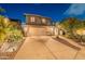 Stunning two-story home with a spacious driveway and beautiful desert landscaping at 26711 N 21St Dr, Phoenix, AZ 85085