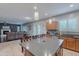 Open floor plan with a kitchen island, dining area, and living room at 26711 N 21St Dr, Phoenix, AZ 85085