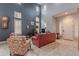 Bright and airy living room featuring tall ceilings, neutral tile flooring, and a cozy seating area at 26711 N 21St Dr, Phoenix, AZ 85085