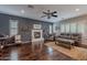 Living room with hardwood floors, a fireplace, and plenty of natural light at 26711 N 21St Dr, Phoenix, AZ 85085