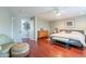 Spacious main bedroom with a ceiling fan, wood floors, and a seating area at 26711 N 21St Dr, Phoenix, AZ 85085