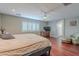 Comfortable bedroom with a ceiling fan, wood floors, and a seating area at 26711 N 21St Dr, Phoenix, AZ 85085