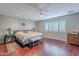 A view of the main bedroom featuring a ceiling fan, wood floors, and bench seating at 26711 N 21St Dr, Phoenix, AZ 85085