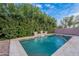 Beautiful pool with a unique waterfall feature and lush landscaping for a resort-style experience at 26711 N 21St Dr, Phoenix, AZ 85085
