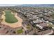 Aerial view of the golf course community, with desert landscaping, tile roofs and mountain views at 27248 W Mohawk Ln, Buckeye, AZ 85396