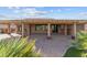 Covered back patio with brick pavers, offering a comfortable outdoor living area at 27248 W Mohawk Ln, Buckeye, AZ 85396
