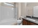 Clean bathroom features a shower-tub combo, sleek vanity, and tiled flooring at 27248 W Mohawk Ln, Buckeye, AZ 85396